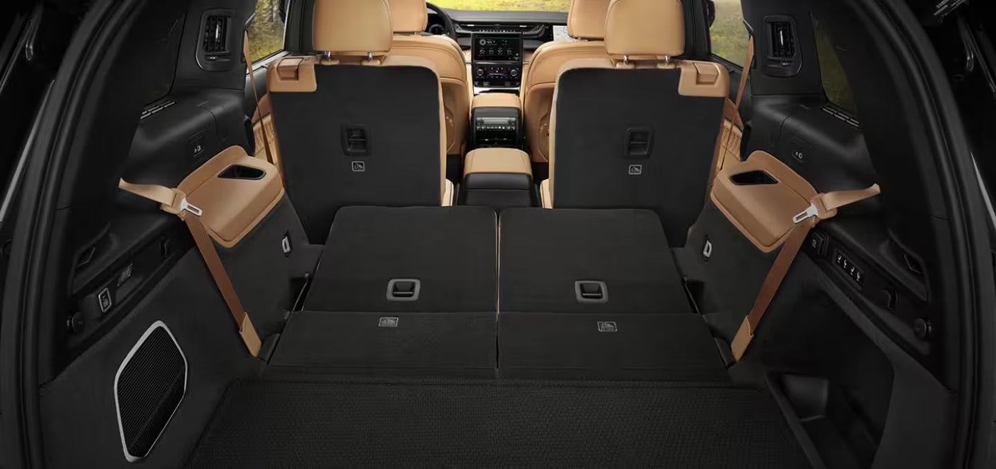 the back interior of an suv with the seats folded down